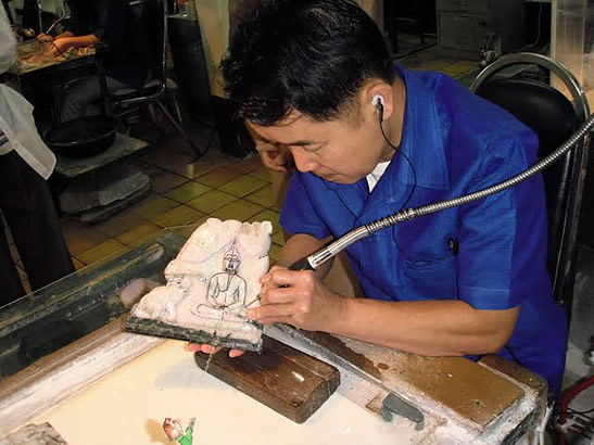 man at work at the Orchid Jade factory, Chiang Mai, Thailand