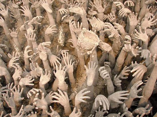 outstretched hands at the White Temple near Chiang Rai, Thailand
