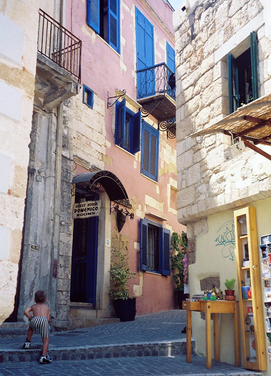 a child playing at one of the alleys in Chania's old Venetian quarter