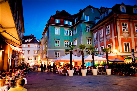 cafes along a street in Graz at night