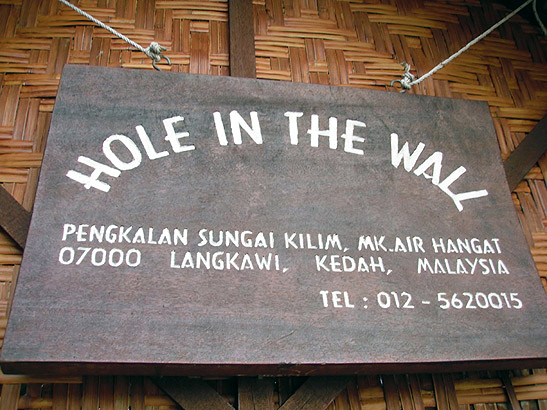 sign for Hole in the Wall restaurant and fish farm