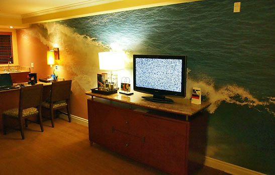 a room at the Hotel Indigo with surfing mural on living room wall
