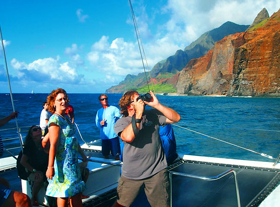 tourists on board Holo Holo Charters' catamaran Leila viewing the Napali Coast