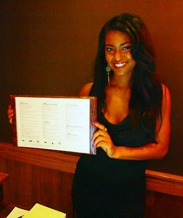 waitress presenting the menu at the Figoly gourmet restaurant