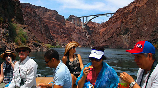 guests on the Black Canyon Raft Tour with the Mike O'Callaghan-Pat Tillman Memorial Bridge in the background