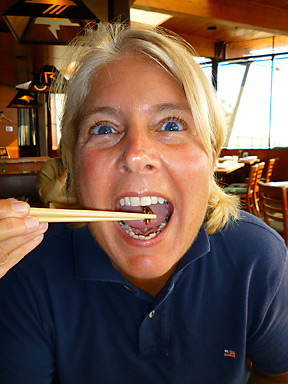 the writer's friend dining on a piece of scorpion with chopsticks at the Typhoon Restaurant