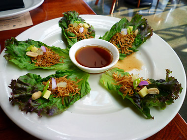 Thai-style sea worms, deep-fried on top of baby lettuce leaves, with spices and accompanied with a tamarind dipping sauce