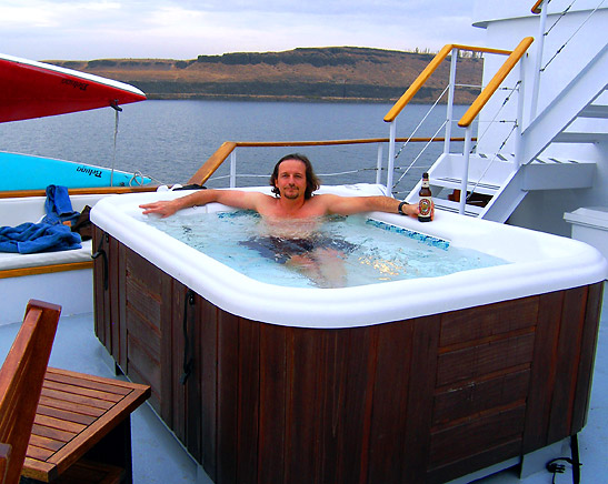 the writer in a Jacuzzi on board the Safari Spirit with the Columbia River in the background