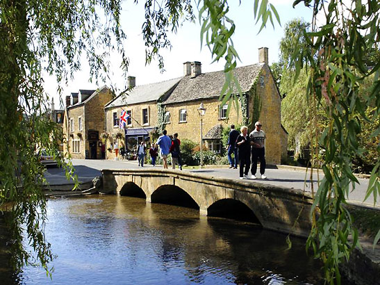pedestrian stone foot bridge over the Windrush River, Bourton-on-the-Water, Cotswolds region, England