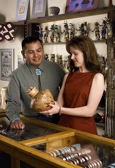 visitor looking at artifact on sale at one of Flagstaff's many shops specializing in native art