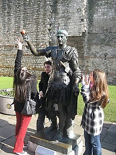 writer and friends around statue of Caesar, Tower of London