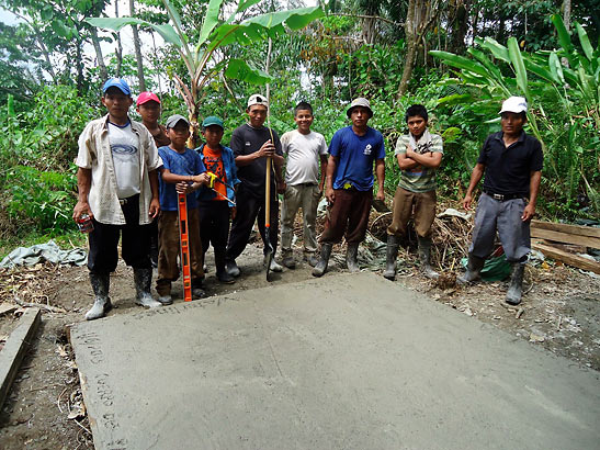 workers posing after pouring concrete for water tank foundation