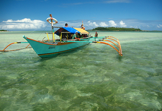 motorized outrigger boat in very shallow water, Caramoan
