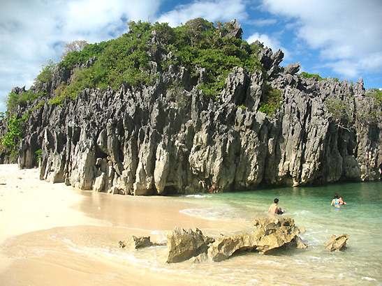 bathers swimming in the shallows of Lahos Island