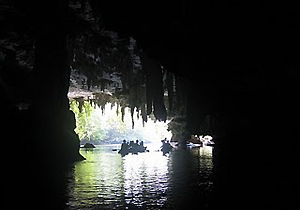 boats cruising inside limestone cave, Krabi