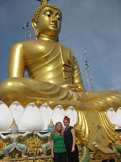 writer and friendin front of a golden Buddha, Krabi