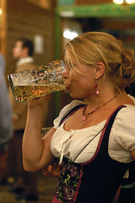German lady downing a mug of beer