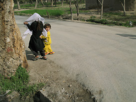 Afghan girls running away from camera