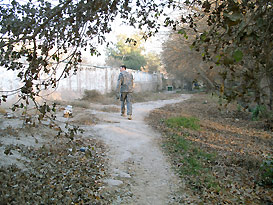 US Army soldier on pathway along wall