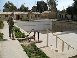 US soldier looking at empty pool