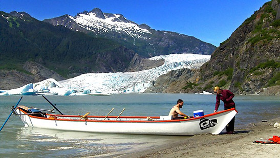 a couple and a canoe at the Mendenhall glacier