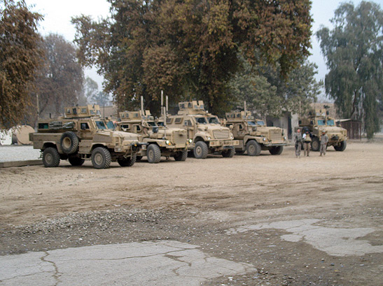 a row of MRAPs (mine-resistant ambush-protected vehicles) in Camp Hughie