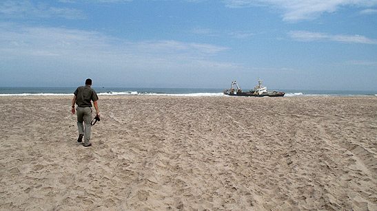 Dave Disi walking on the beach towards the wreck of the freighter Zeila