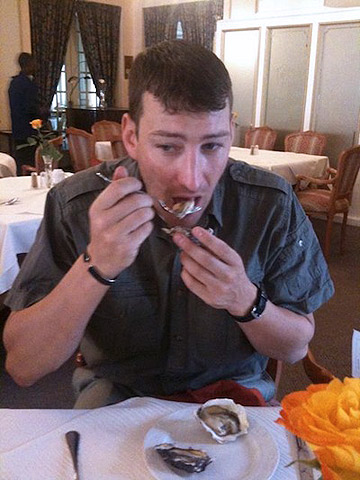 Dave disi tries oysters at a restaurant in Swakopmund