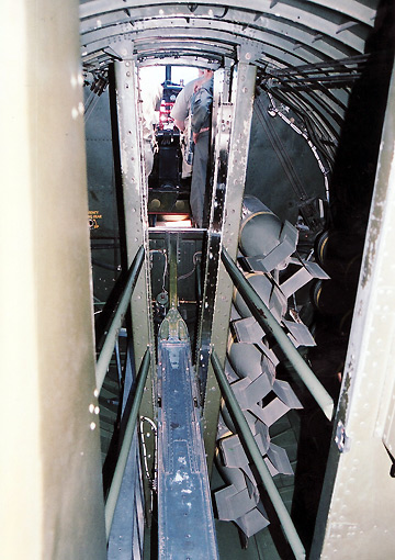 view inside B17 bomb bay showing bomb replicas and pilot cabin in the background