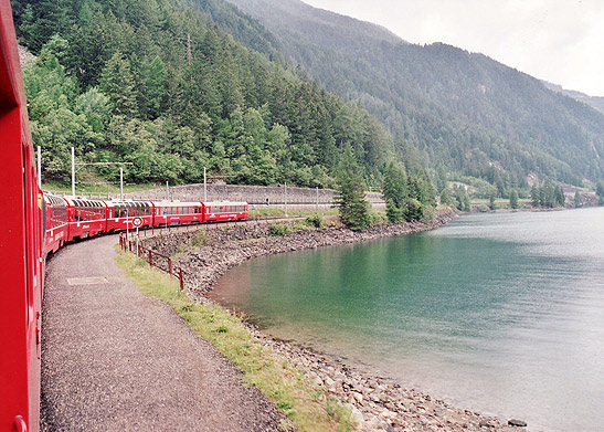 Bernina Express train passing by a lake, Switzerland