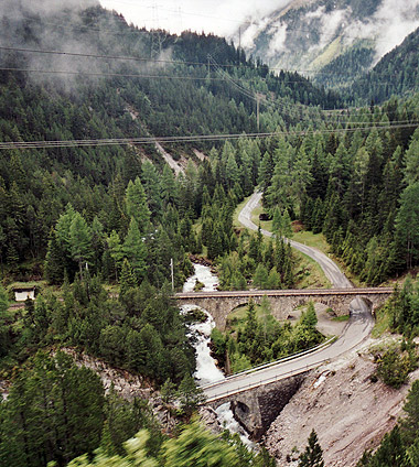 view of rolling countryside from aboard the Bernina Express train