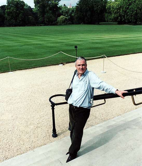 the writer standing at the back of Buckingham Palace