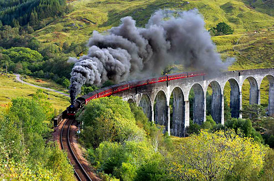 steam train crossing the Glenfinnan Viaduct, Scotland