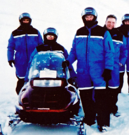 writer and fellow travel journalists in snowmobile suits