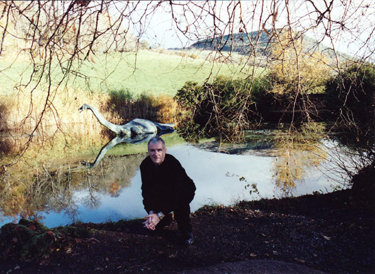 writer with replica of the Loch Ness monster in background