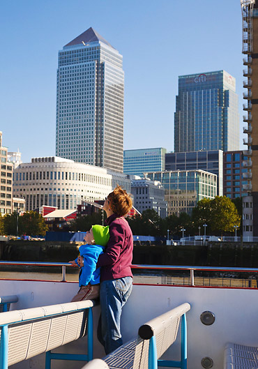 mother and child gazing at skyscrapers in Canary Wharf, East London