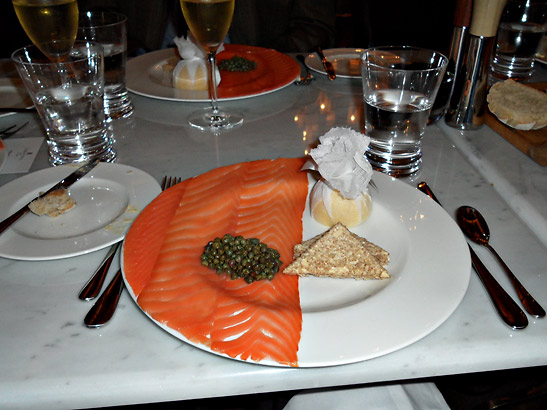 thinly sliced salmon on plate at The Corinthia Hotel