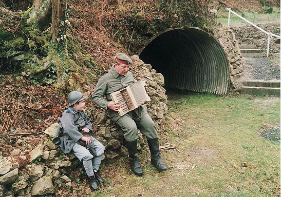 boy and man with accordion in World War 1 uniforms