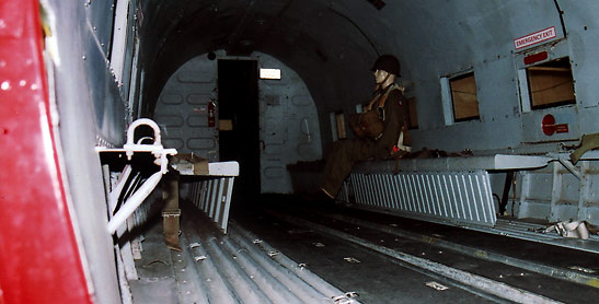 interior of a C47 transport plane with a model of a paratrooper, Palm Springs Air Museum