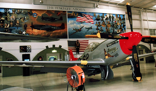 P51 Mustang behind a mural featuring the Tuskegee Airmen of World War 2