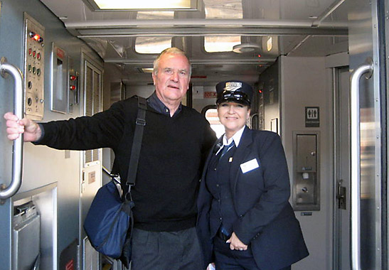 the writer with train conductor Marcy Houston st the doorway of an Amtrak Pacific Surf Liner