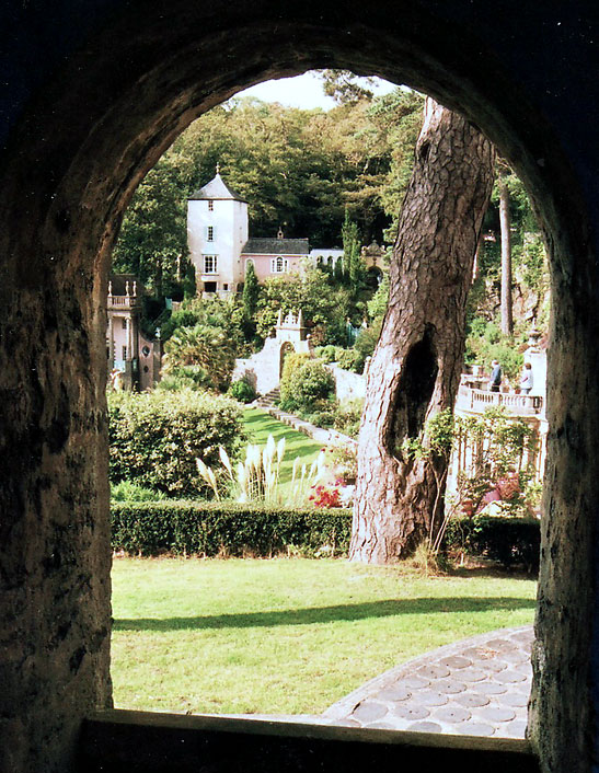 view of a village from a arched stone window