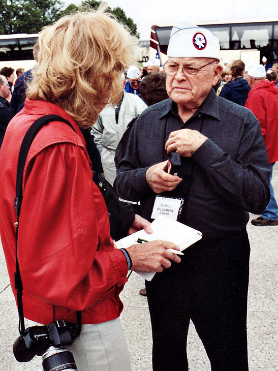 WW2 veteran Francis Williamson being interviewed by a Stars and Stripes writer at the Henri Chapelle Cemetery, Belgium