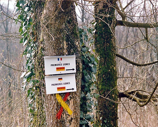 small signs on tree pointing to the German and French trenches