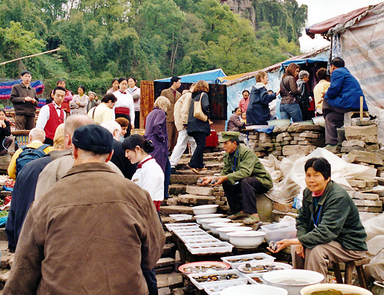 local sellers on the steps to an old building along the Yangtze River