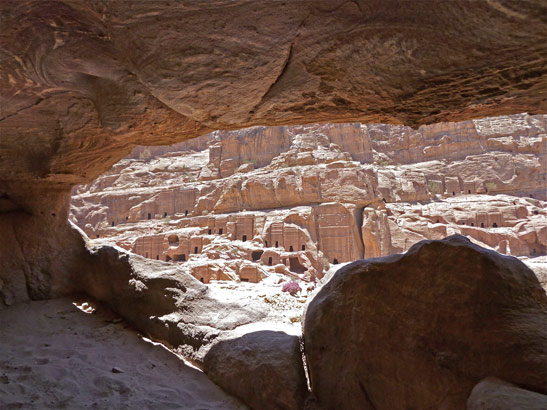 view of ancient buildings at Petra from inside a cave