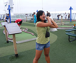 playing at the mini-golf course onboard