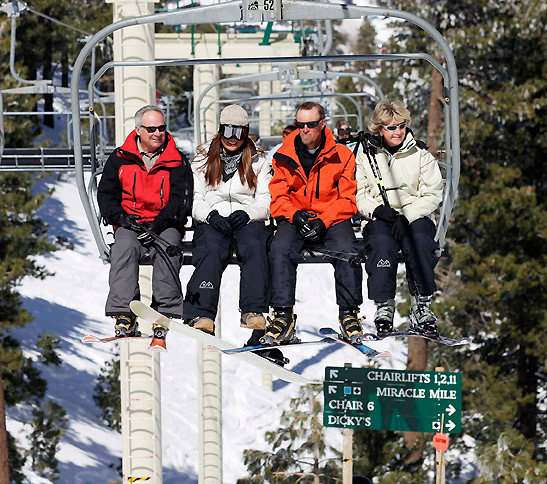 skiiers riding a chairlift