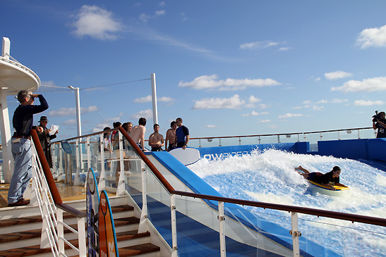 guest riding the waves at one of the two FloRiders on the Oasis