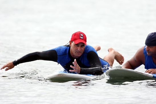 instructor giving pointers at surfing school